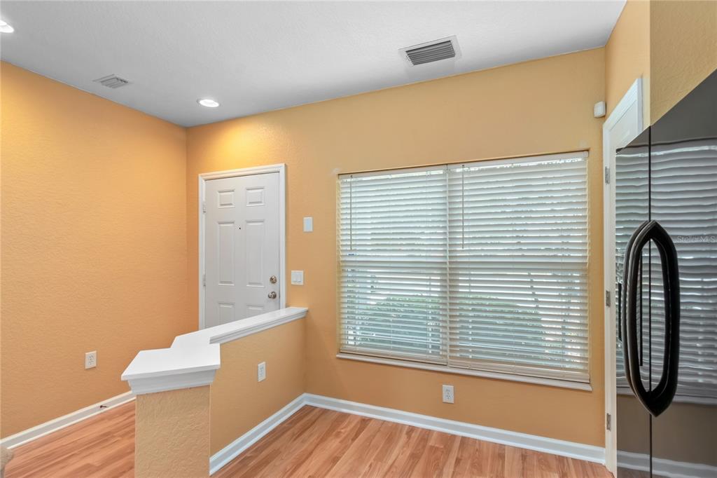 4814 Southwest 44th Circle Ocala, FL 34474 - Photo 8 of 40 a view of a room with a large window and wooden floor