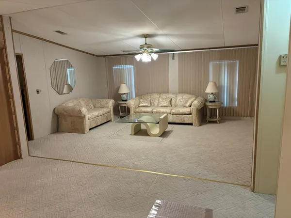 a living room with furniture and a chandelier