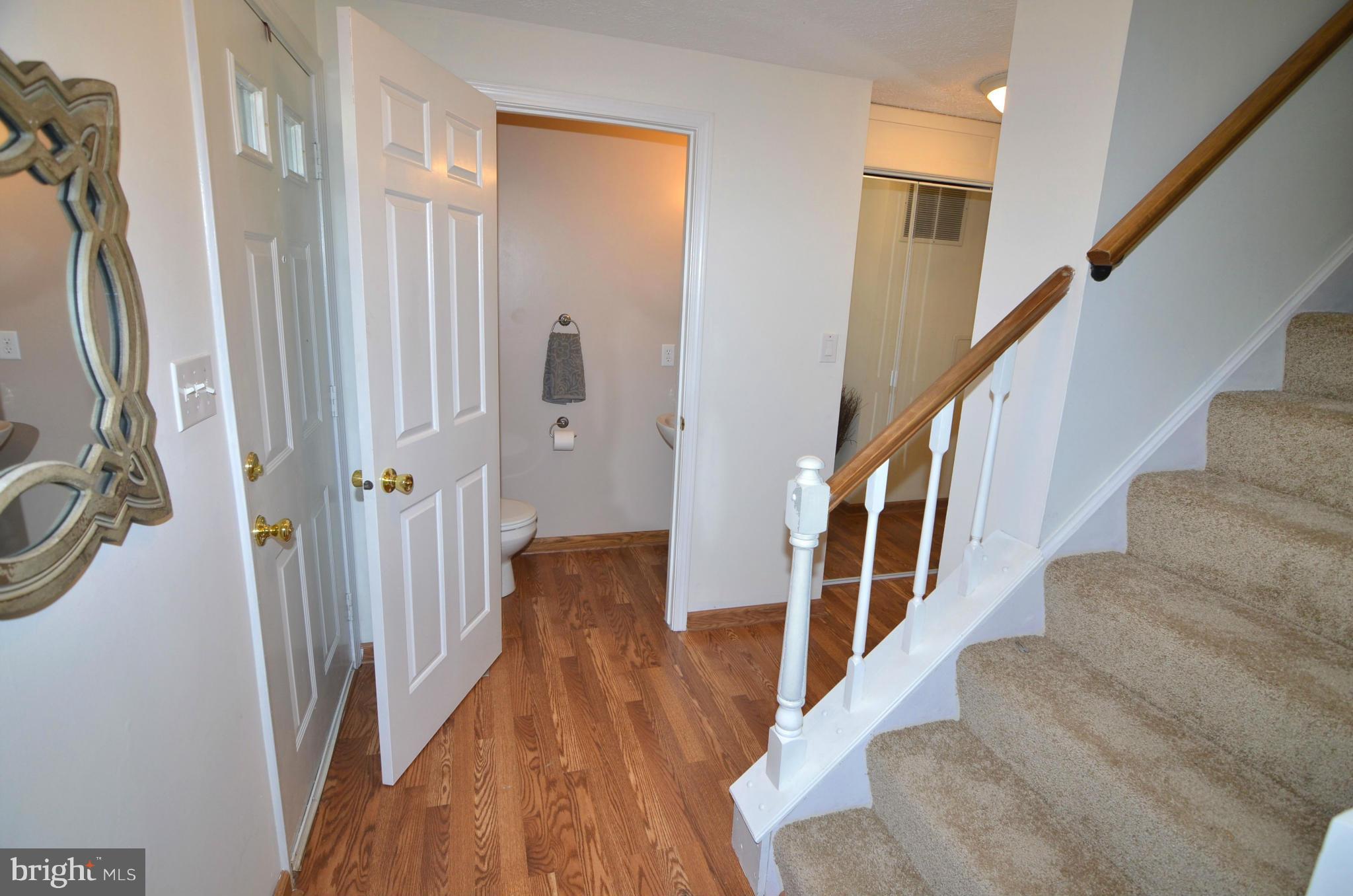 1503 Strider Court Hanover, MD 21076 - Photo 3 of 30 a view of a hallway with wooden floor and staircase
