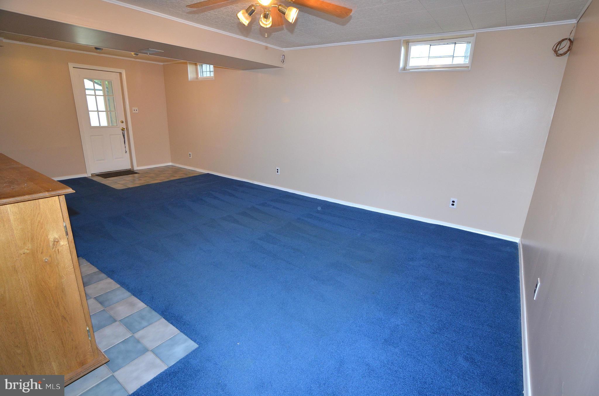 1503 Strider Court Hanover, MD 21076 - Photo 25 of 30 an empty room with wooden floor chandelier fan and windows