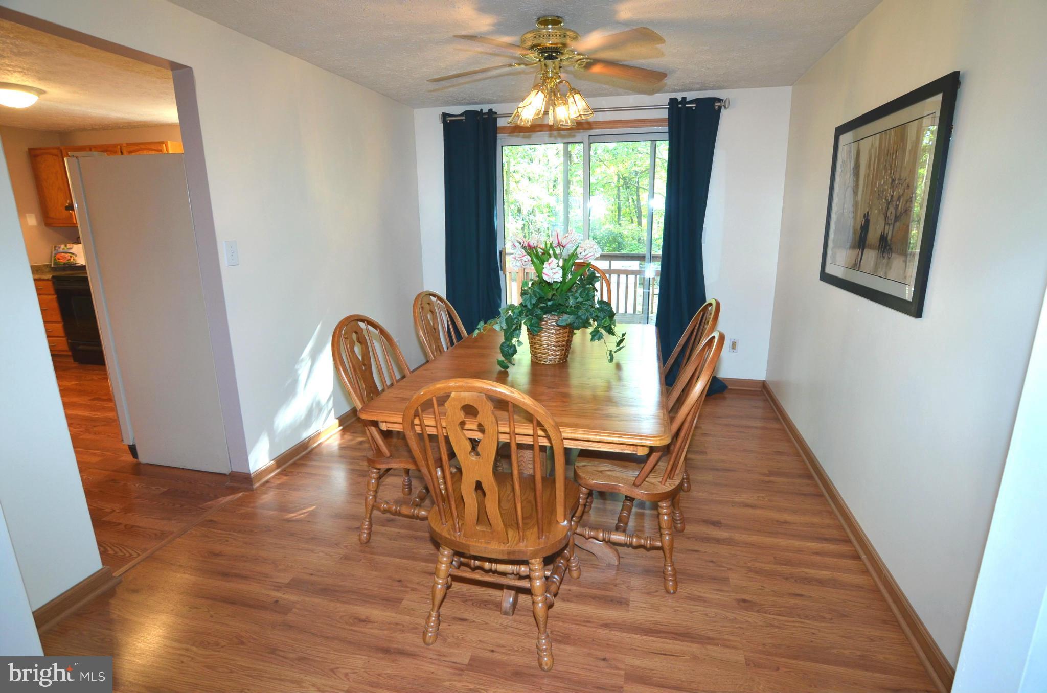 1503 Strider Court Hanover, MD 21076 - Photo 7 of 30 a view of a dining room with furniture window and wooden floor