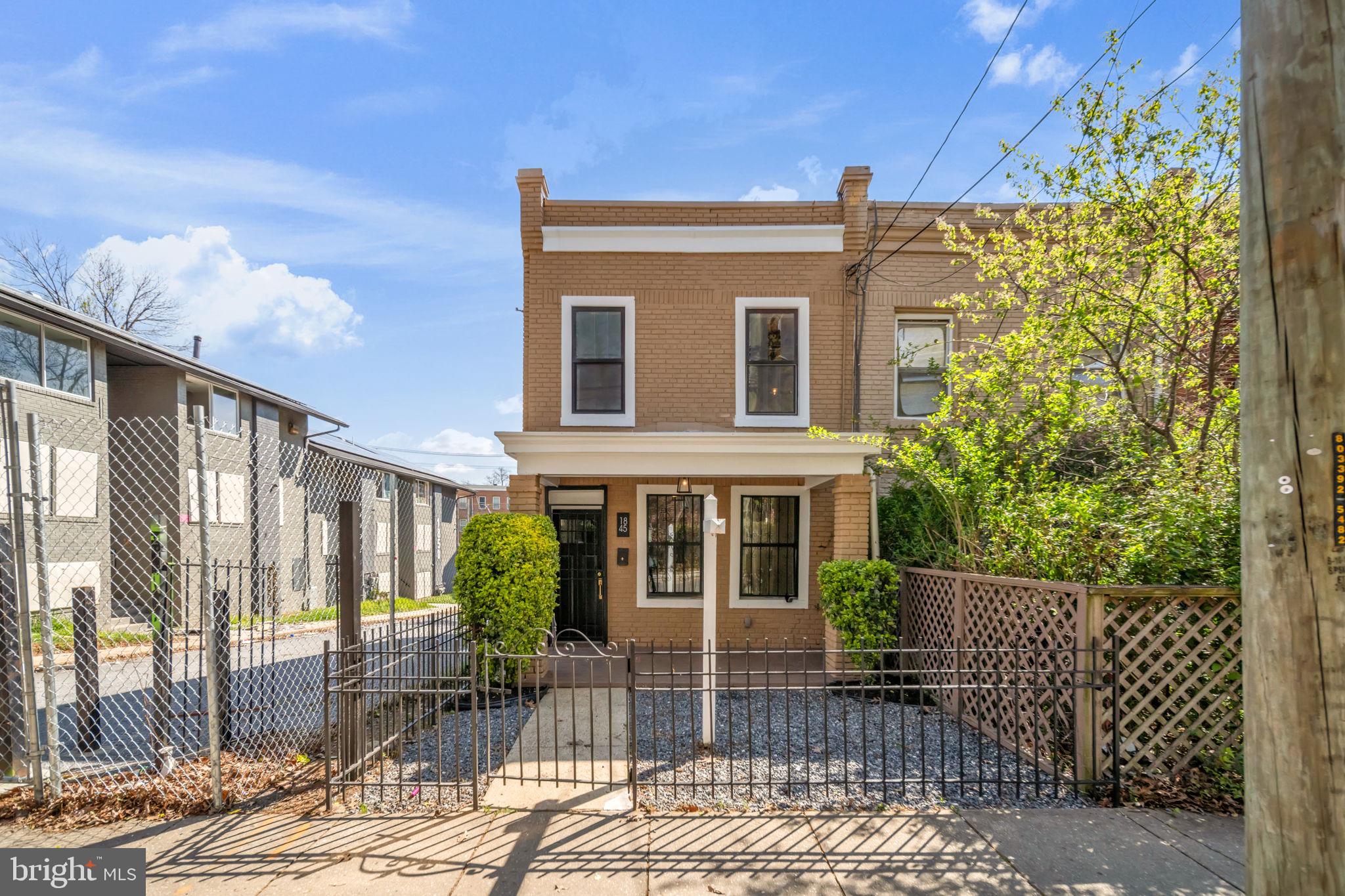 1845 Corcoran Street Northeast Washington, DC 20002 - Photo 29 of 33 Charming brick facade with lush greenery.