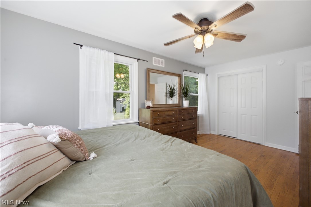 2411 Ridgeview Lane Youngstown, OH 44514 - Photo 19 of 48 Wood-finish flooring throughout, featuring a ceiling fan with integrated lighting, white trim work, and neutral wall tones