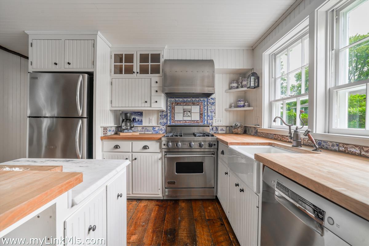 14 & 16 Coffin Street Nantucket, MA 02554 - Photo 34 of 50 a kitchen with a stove a sink and a refrigerator