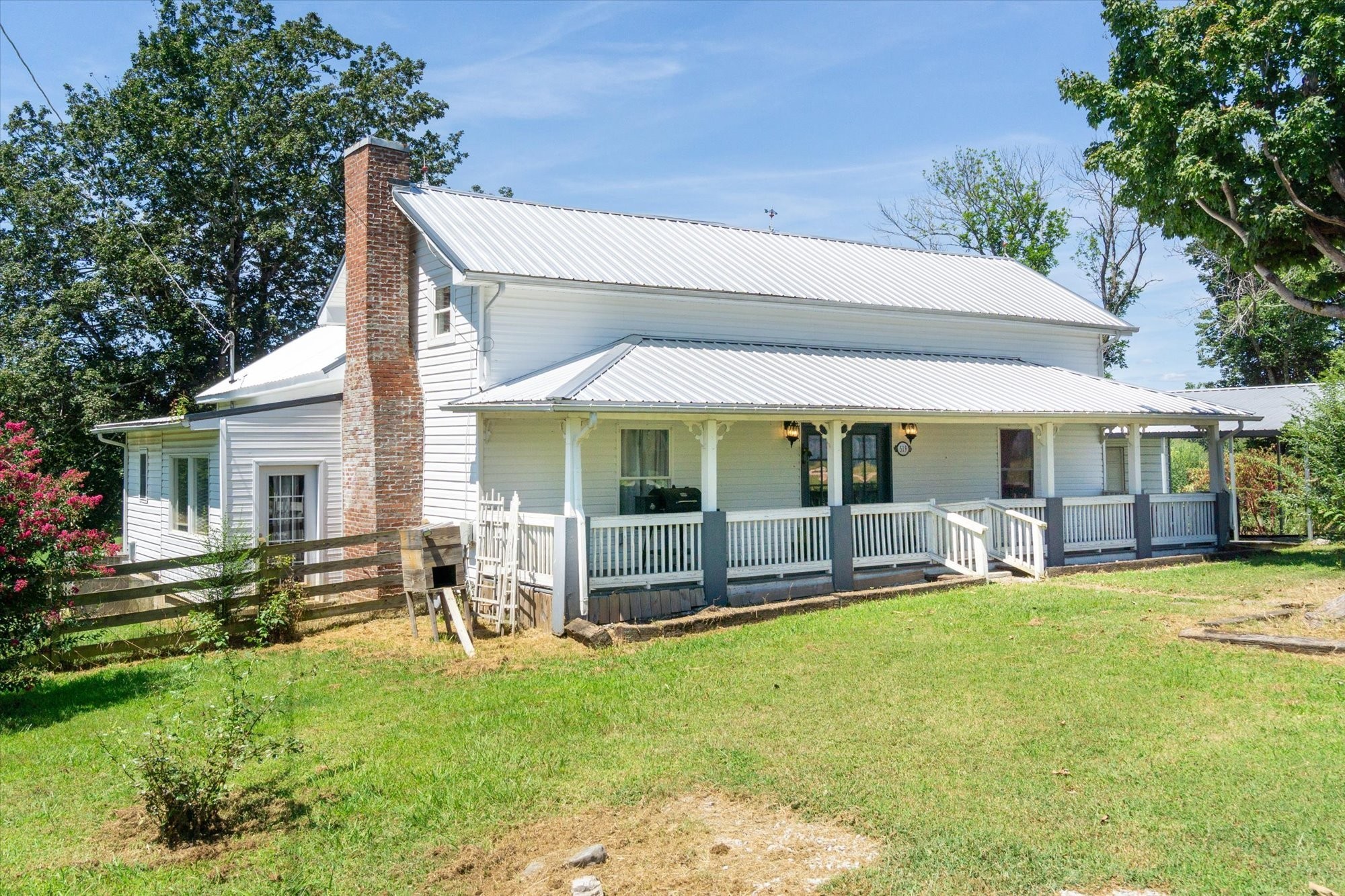 a view of a house with swimming pool and porch with furniture