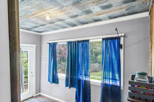a view of a hallway with a large window and wooden floor
