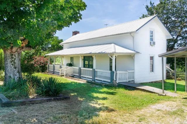 a view of a house with backyard and porch
