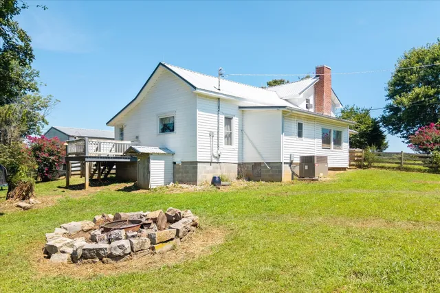 a front view of house with yard outdoor seating and barbeque oven