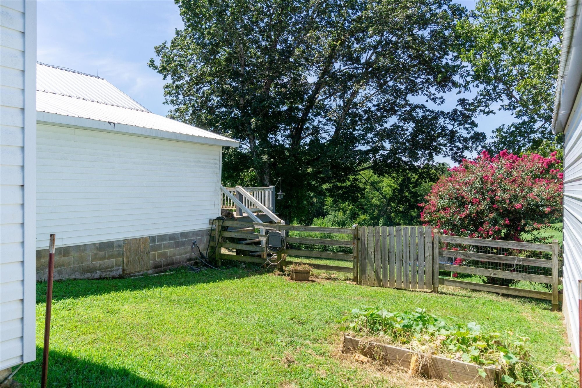 519 John McCoin Road Sparta, TN 38583 - Photo 9 of 27 a view of backyard with wooden fence and a slide