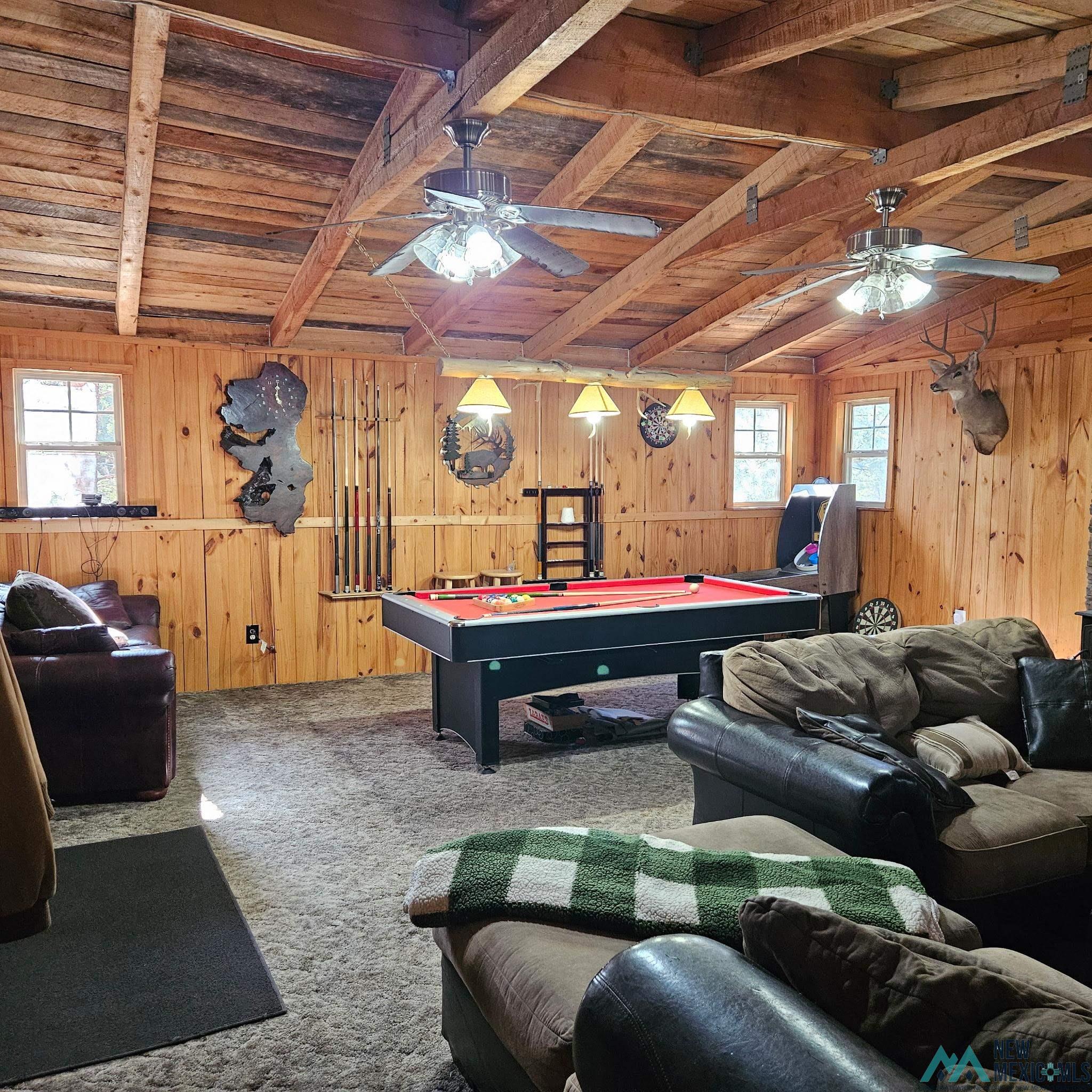 3 Wimsatt Road Cloudcroft, NM 88317 - Photo 8 of 41 Rec room featuring pool table, carpet flooring, wood walls, a wood ceiling with exposed beams, and a ceiling fan