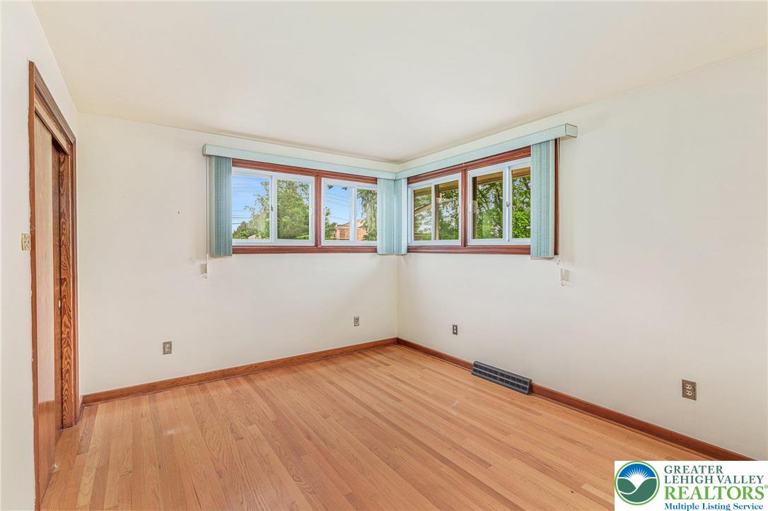 194 Gallagher Road Whitehall, PA 18052 - Photo 13 of 21 an empty room with wooden floor and windows