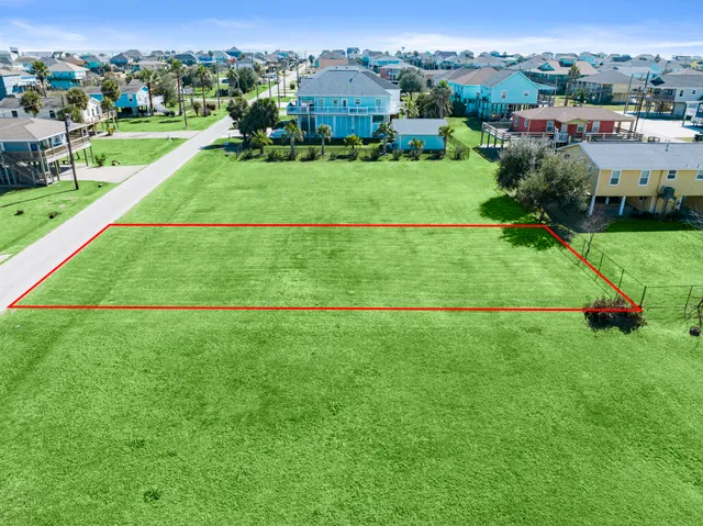 an aerial view of a houses with outdoor space and street view