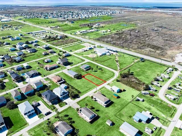 an aerial view of residential houses with outdoor space and street view