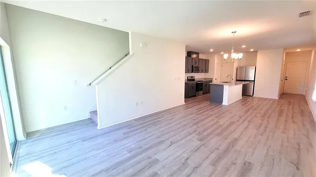 a view of a kitchen with a sink and microwave