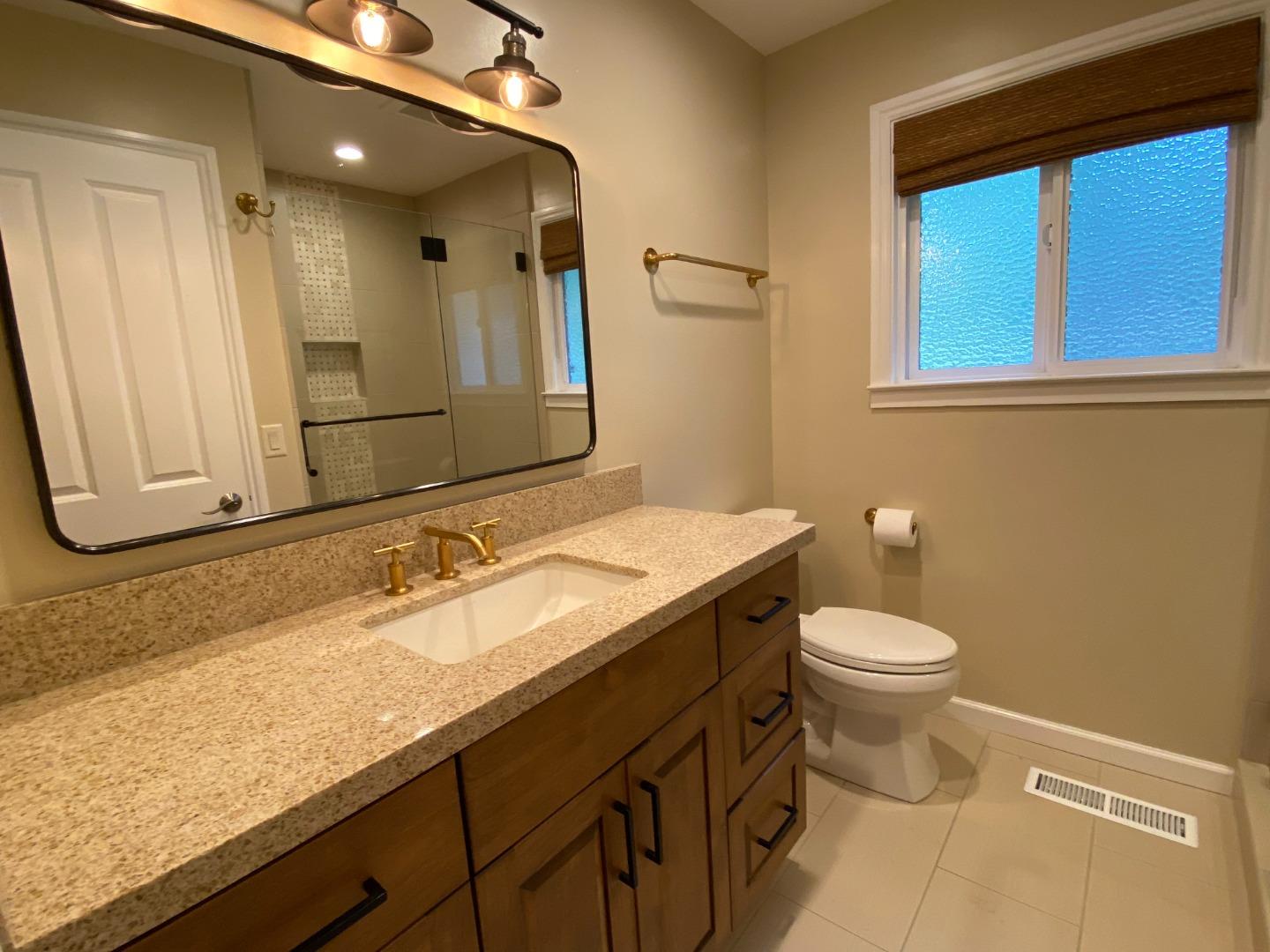 7 Vía Del Sol Watsonville, CA 95076 - Photo 12 of 21 a bathroom with a granite countertop sink mirror and a toilet