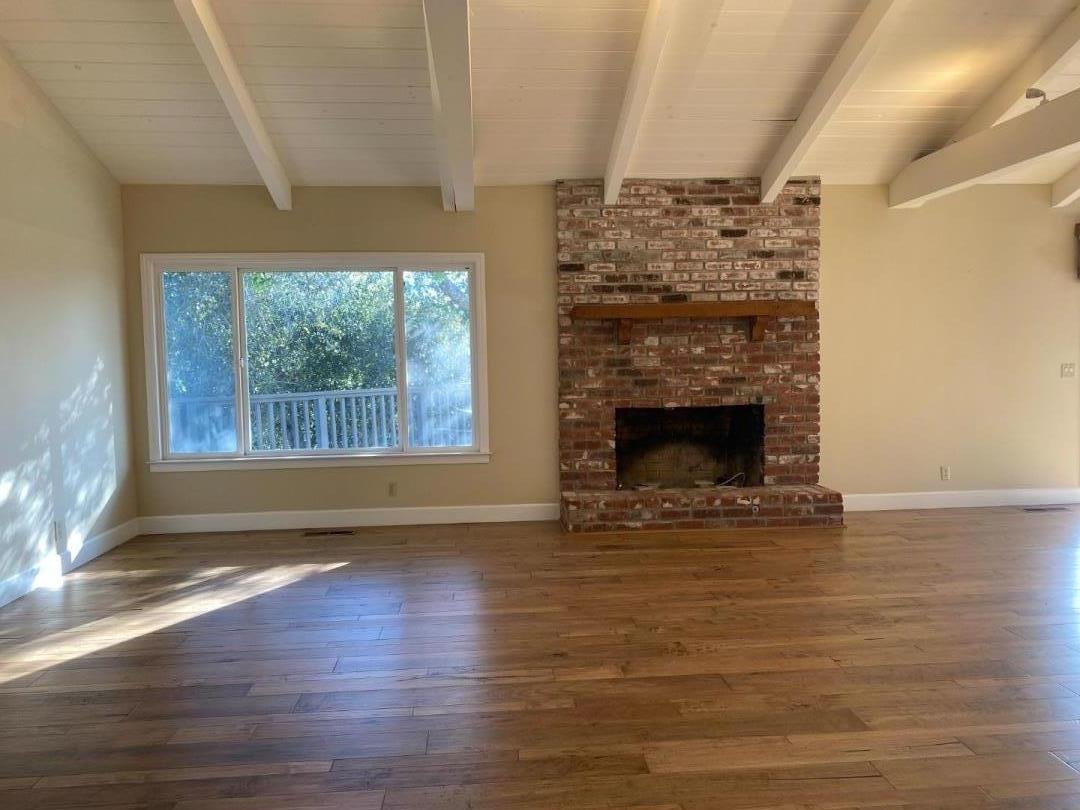 7 Vía Del Sol Watsonville, CA 95076 - Photo 13 of 21 a view of empty room with wooden floor and fireplace