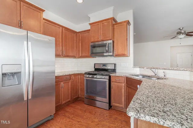 a view of kitchen appliances and wooden floor