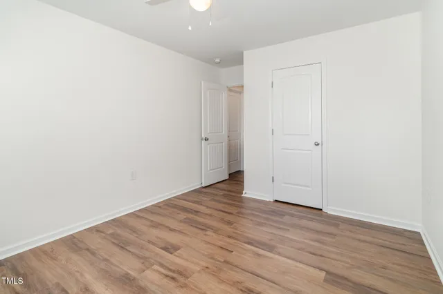 a bedroom with bed and a large mirror