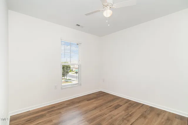 a bathroom with a granite countertop sink a toilet a mirror a vanity a bath tub and shower