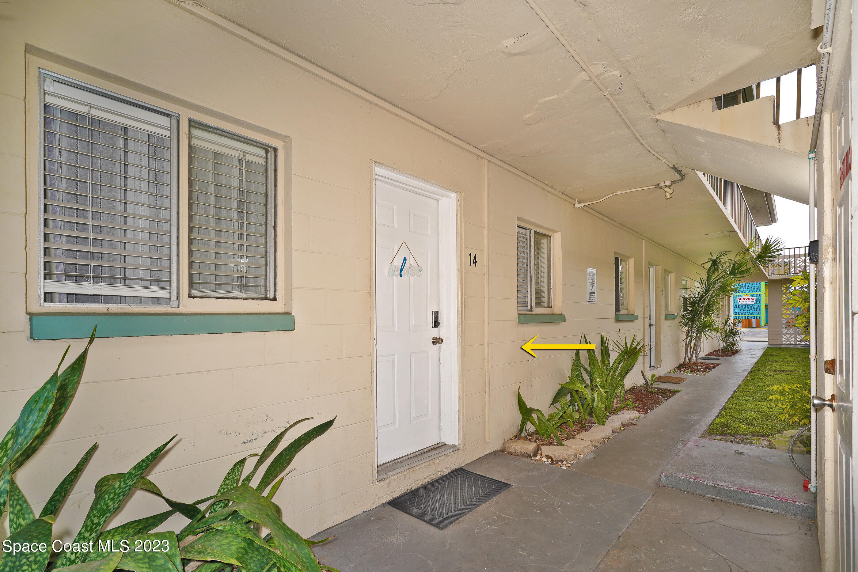 404 Tyler Avenue, Unit 14 Cape Canaveral, FL 32920 - Photo 15 of 29 a view of a porch with chairs and potted plants