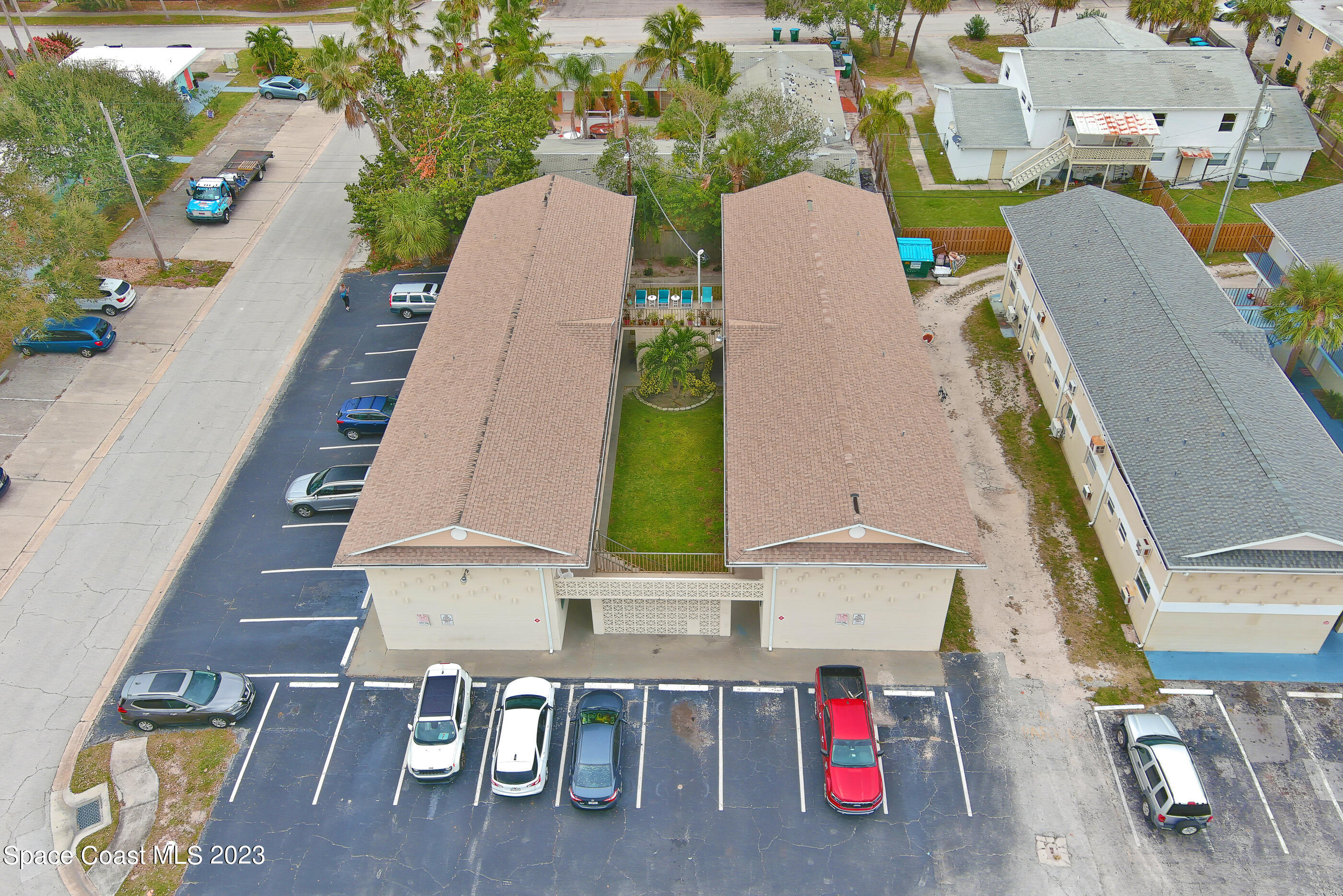 404 Tyler Avenue, Unit 14 Cape Canaveral, FL 32920 - Photo 22 of 29 an aerial view of multiple houses with outdoor space