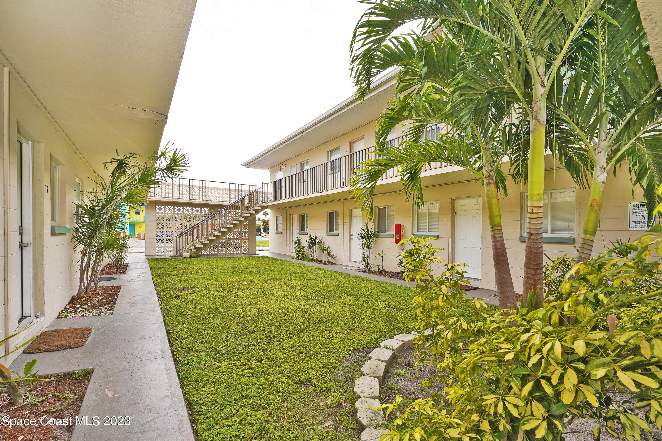 404 Tyler Avenue, Unit 14 Cape Canaveral, FL 32920 - Photo 24 of 29 a front view of a house with a garden