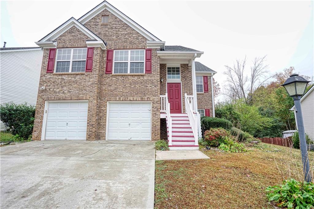893 Hawthorn Lane Grayson, GA 30017 - Photo 1 of 1 a front view of a house with a yard and garage