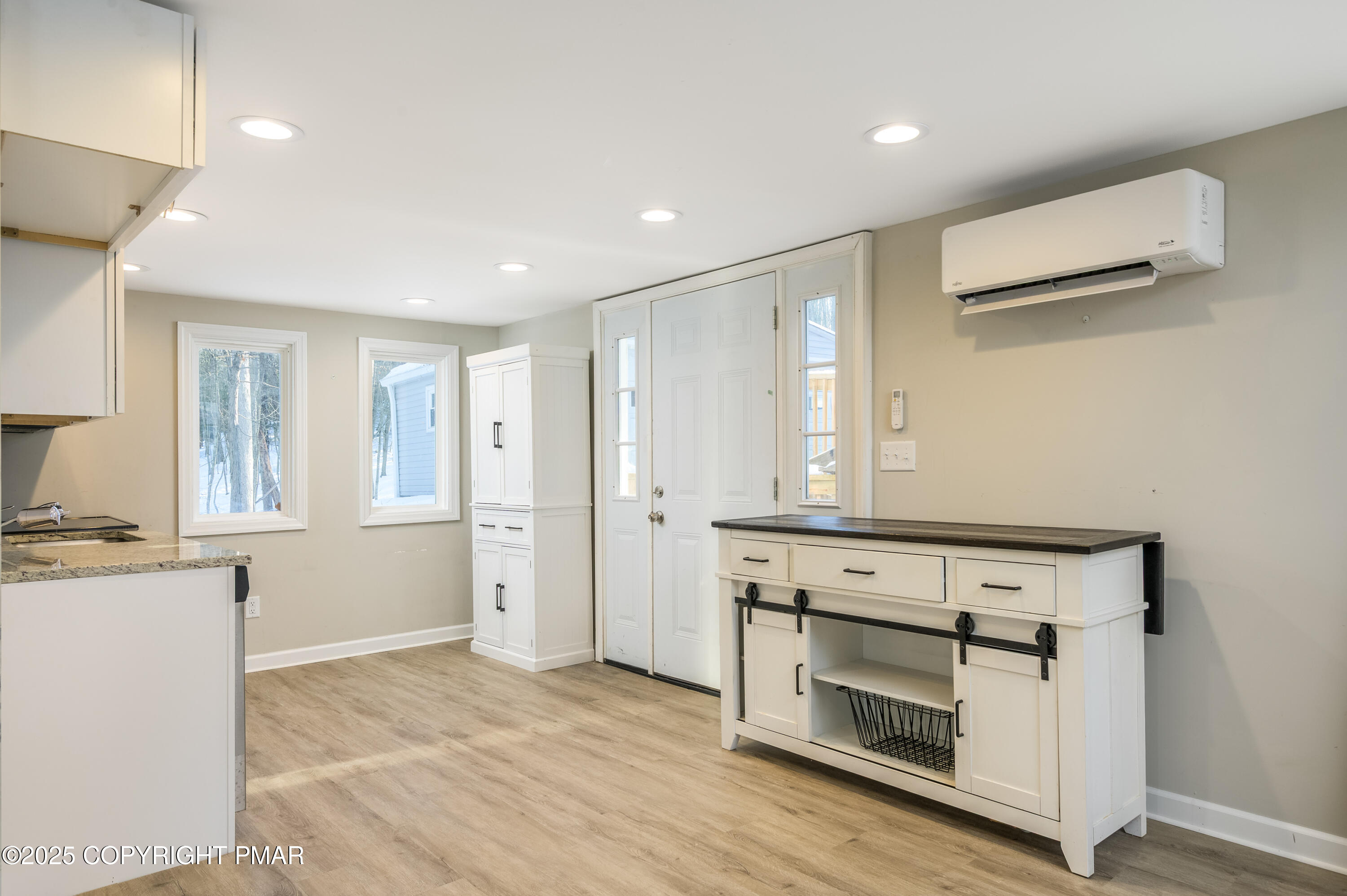 6151 Kansa Road East Stroudsburg, PA 18302 - Photo 10 of 26 a view of an empty room with a fireplace and wooden cabinets