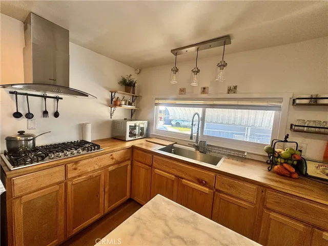 a kitchen with cabinets a sink and appliances