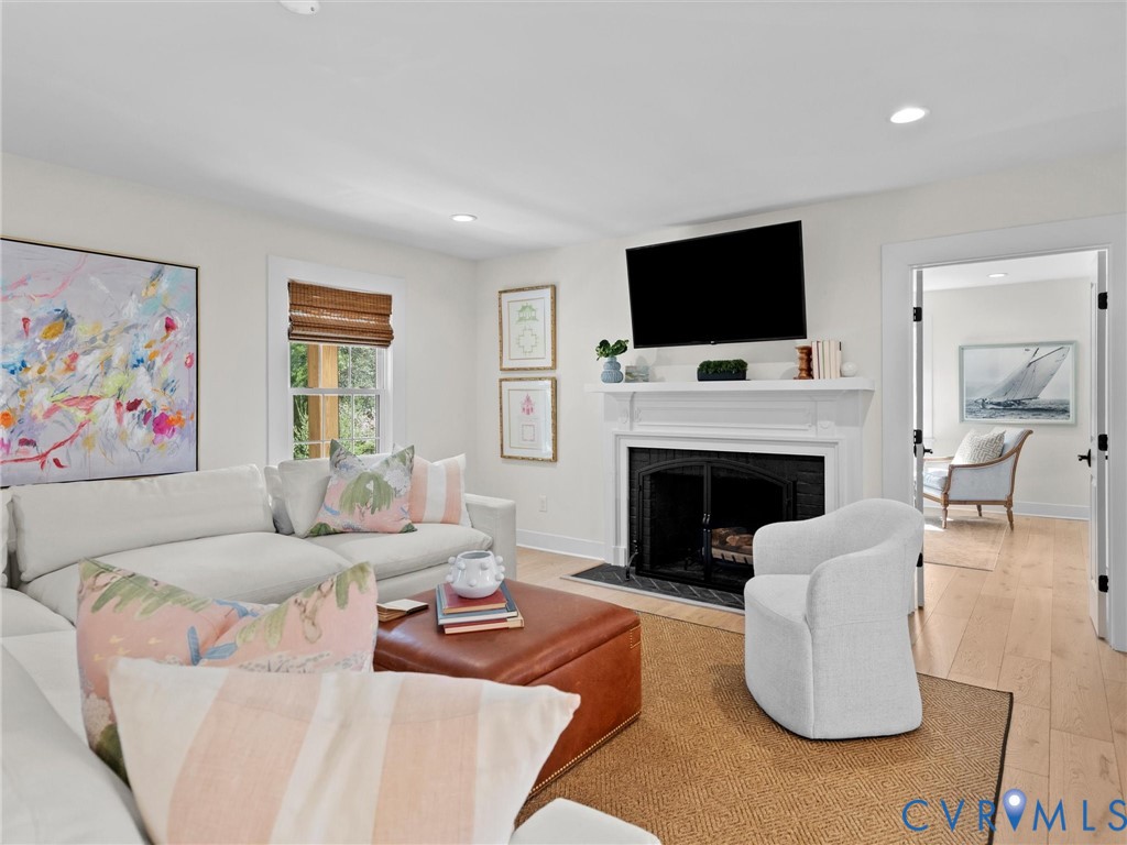 200 North Ridge Road Henrico, VA 23229 - Photo 12 of 85 a living room with furniture a flat screen tv and a fireplace