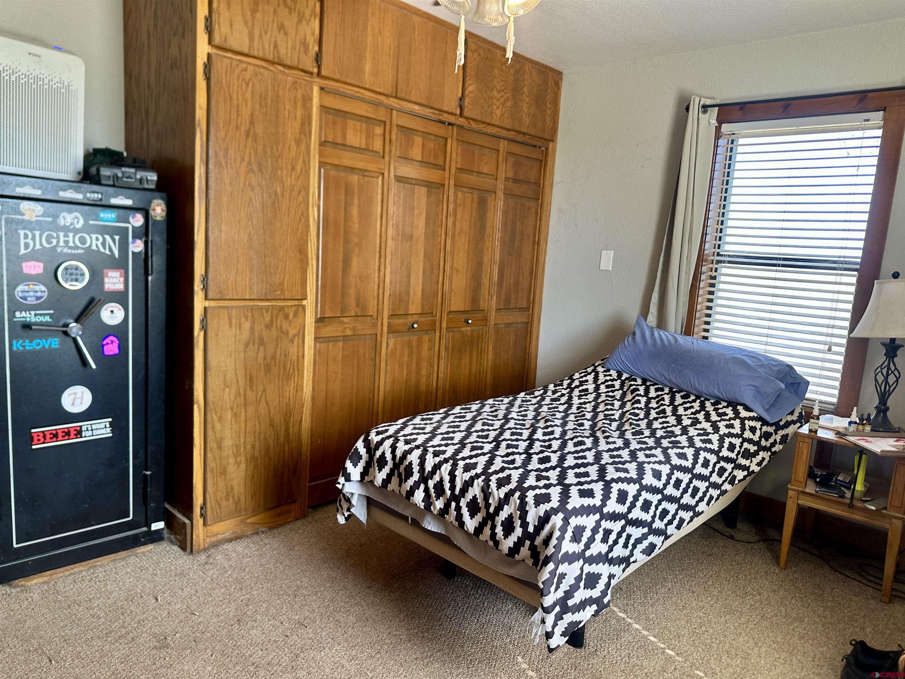 2468 1500th Road Delta, CO 81416 - Photo 14 of 45 a bed sitting in a bedroom next to a window