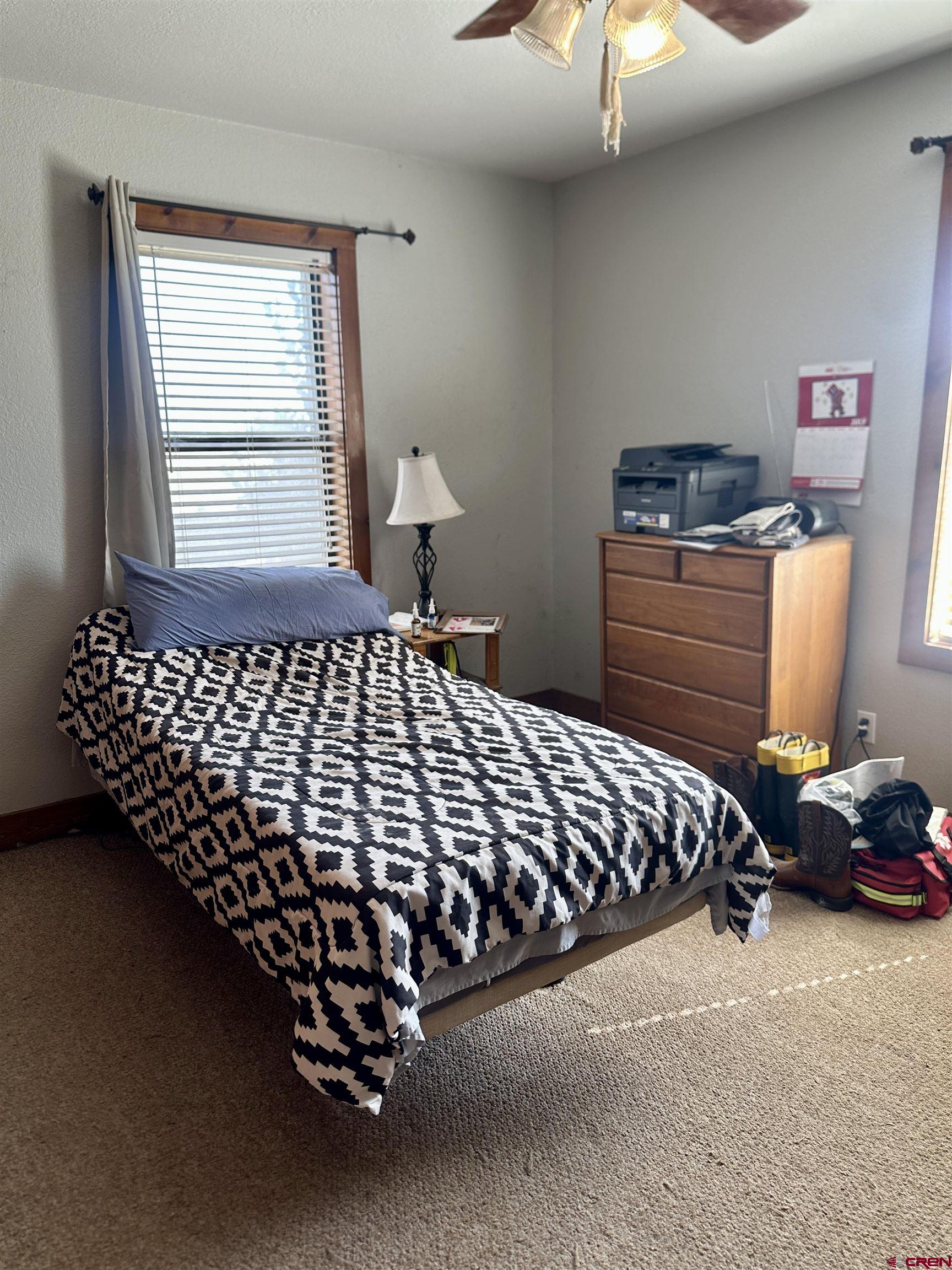 2468 1500th Road Delta, CO 81416 - Photo 15 of 45 a bed sitting in a bedroom next to a window