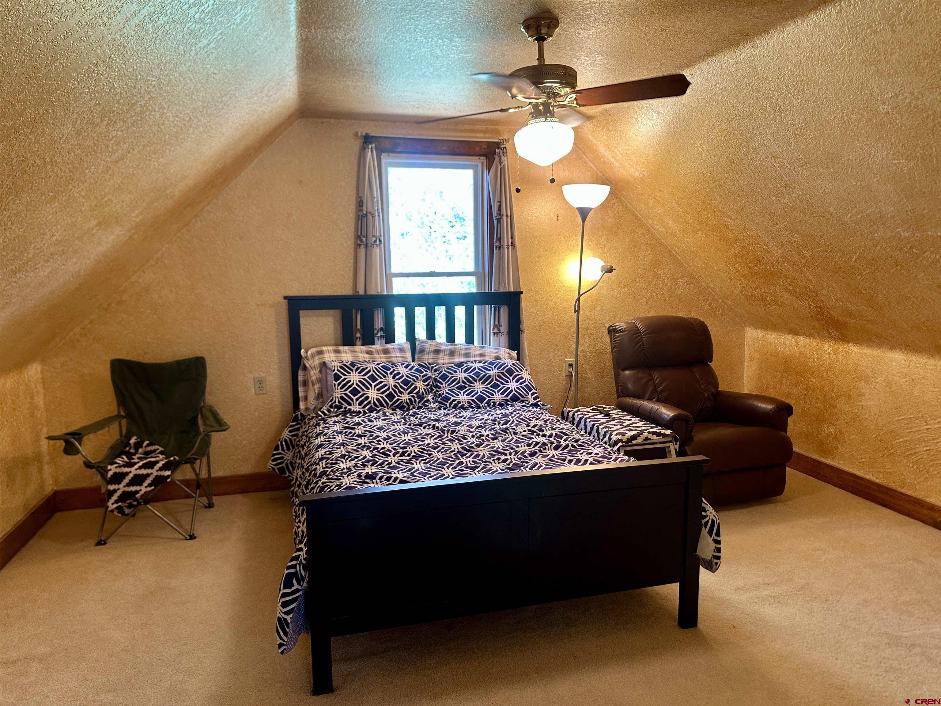 2468 1500th Road Delta, CO 81416 - Photo 18 of 45 a bedroom with bed cabinet and window