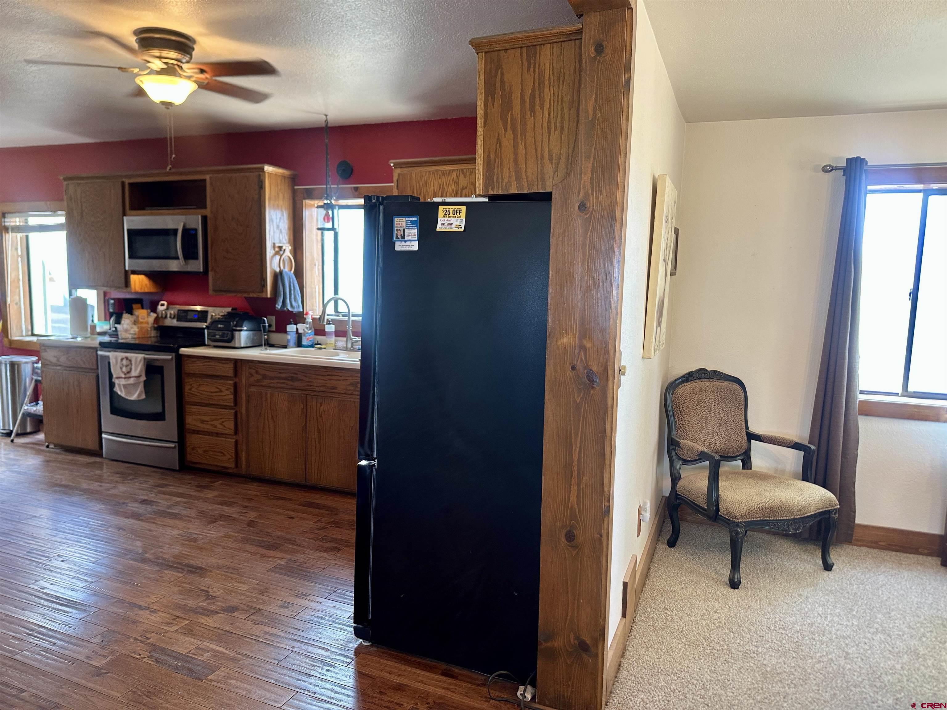 2468 1500th Road Delta, CO 81416 - Photo 9 of 45 a kitchen with stainless steel appliances granite countertop a refrigerator and a stove top oven