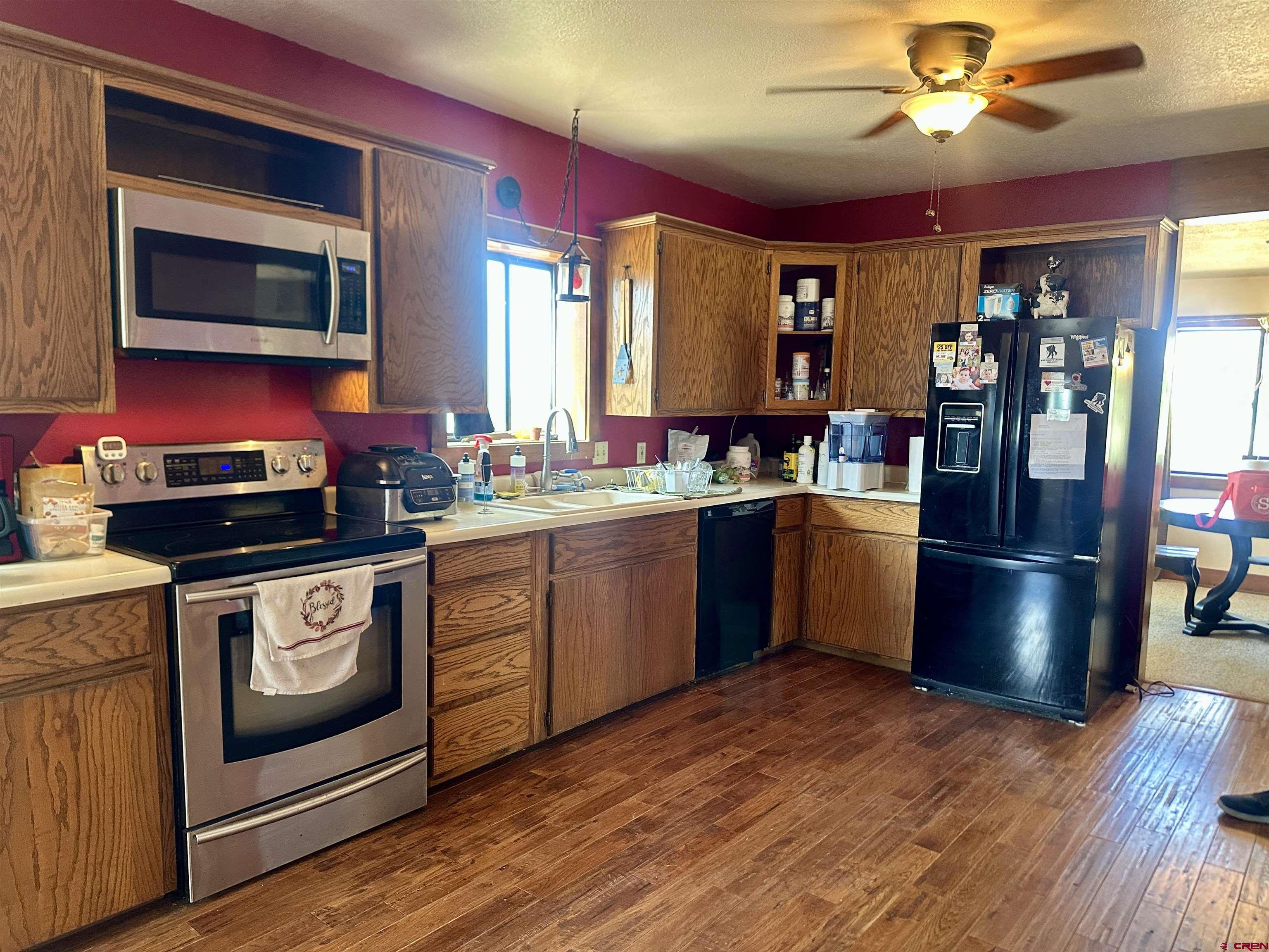 2468 1500th Road Delta, CO 81416 - Photo 10 of 45 a kitchen with stainless steel appliances granite countertop a refrigerator a stove top oven a sink and dishwasher