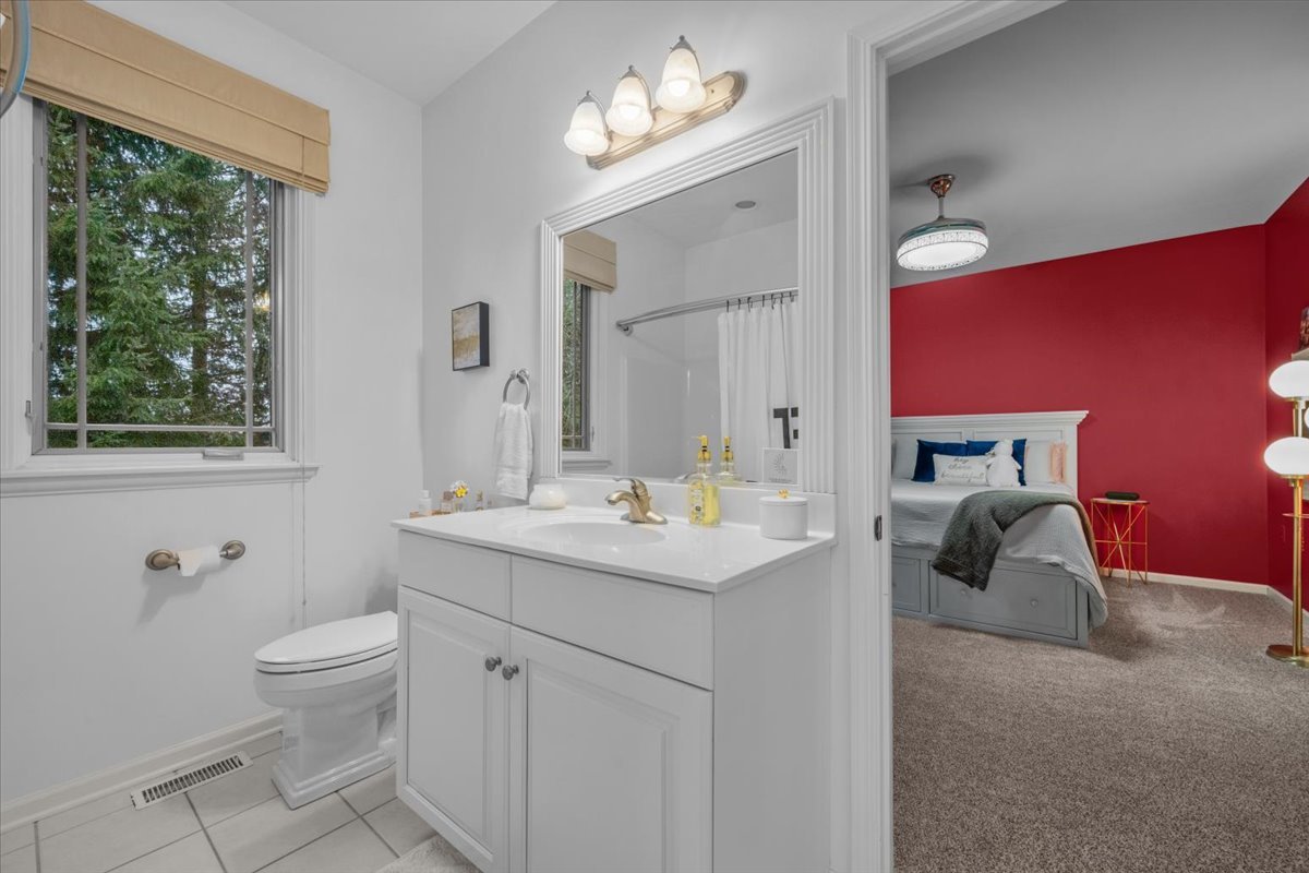 9-n050 Dittman Road Elgin, IL 60124 - Photo 24 of 54 a bathroom with a toilet sink and mirror