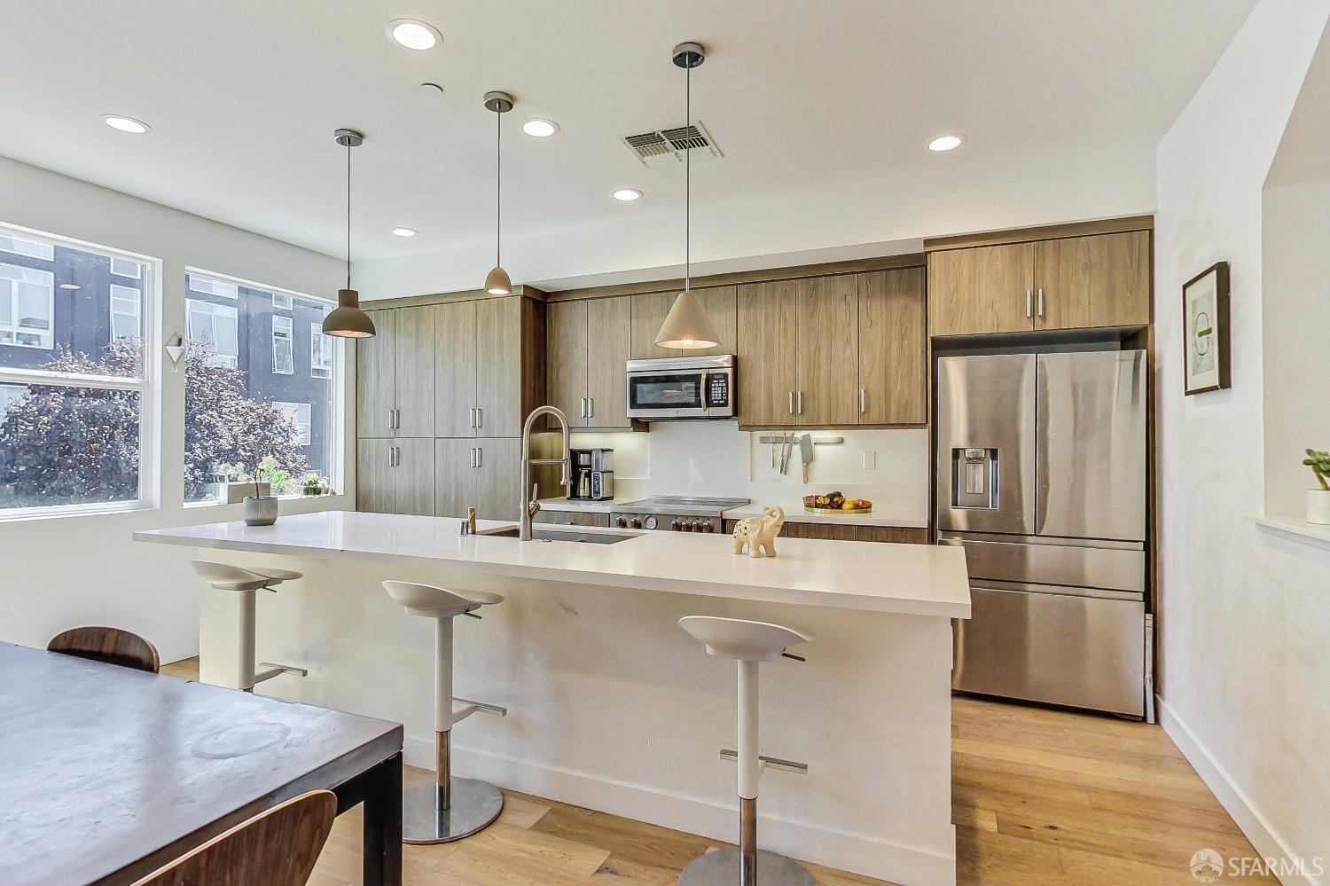 1353 Pullman Way Oakland, CA 94607 - Photo 21 of 55 a kitchen with refrigerator cabinets and wooden floor