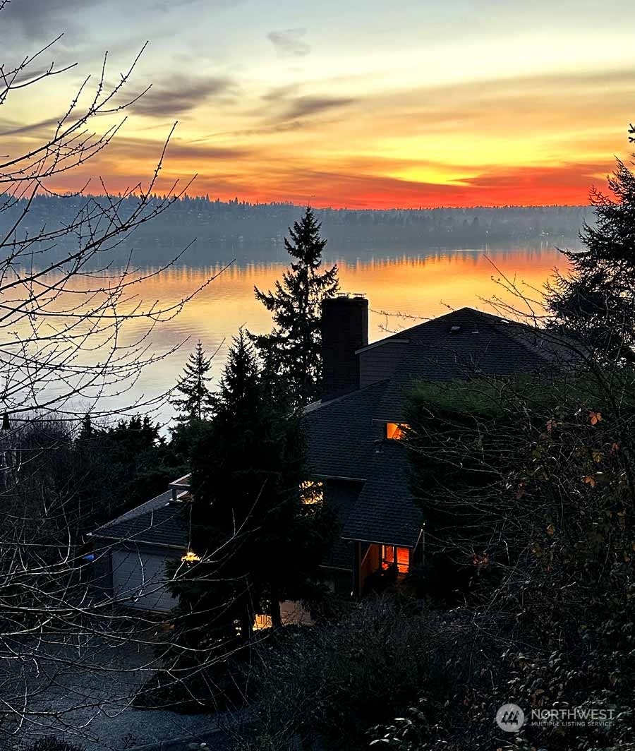 8045 West Mercer Way Mercer Island, WA 98040 - Photo 1 of 38 a sunset view with a garden