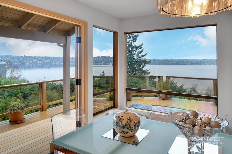 8045 West Mercer Way Mercer Island, WA 98040 - Photo 21 of 38 a living room with a large window and table