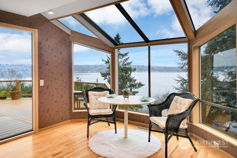 8045 West Mercer Way Mercer Island, WA 98040 - Photo 26 of 38 a dining room with furniture and a floor to ceiling window