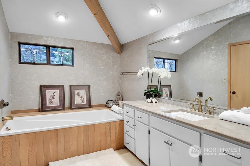 8045 West Mercer Way Mercer Island, WA 98040 - Photo 8 of 38 a spacious bathroom with a double vanity sink and a mirror