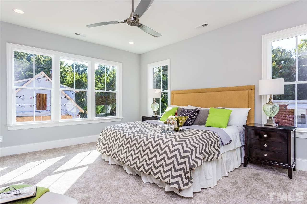 3203.5 Clark Avenue Raleigh, NC 27607 - Photo 18 of 25 a bedroom with a bed a window and a chandelier