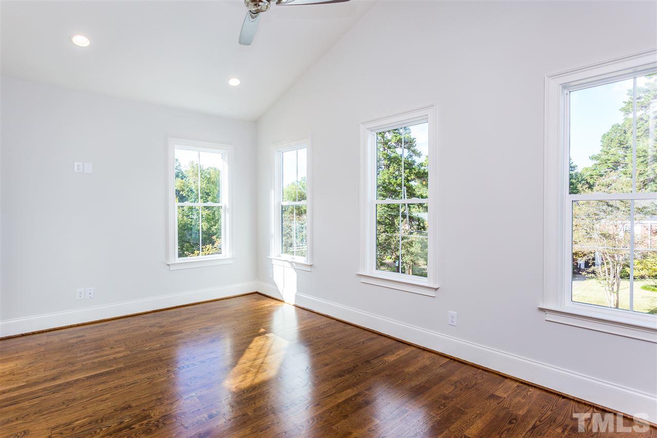 3203.5 Clark Avenue Raleigh, NC 27607 - Photo 22 of 25 a view of an empty room with wooden floor and windows