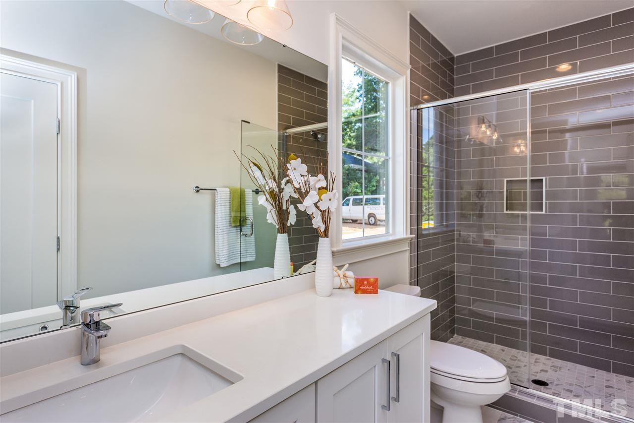 3203.5 Clark Avenue Raleigh, NC 27607 - Photo 6 of 25 a bathroom with a sink a toilet a window and shower