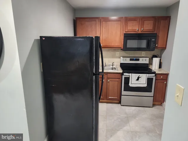 a kitchen with a refrigerator stove and microwave
