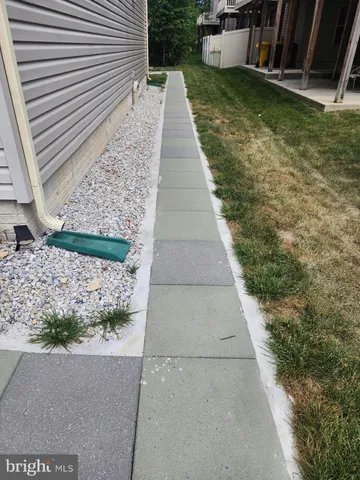 a view of a pathway both side of the house