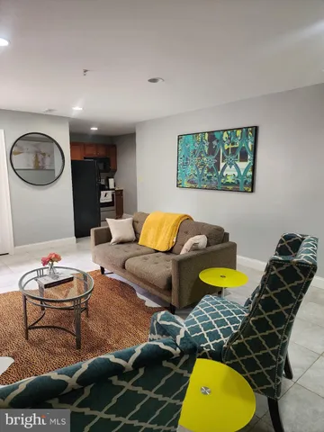 a living room with furniture and a rug