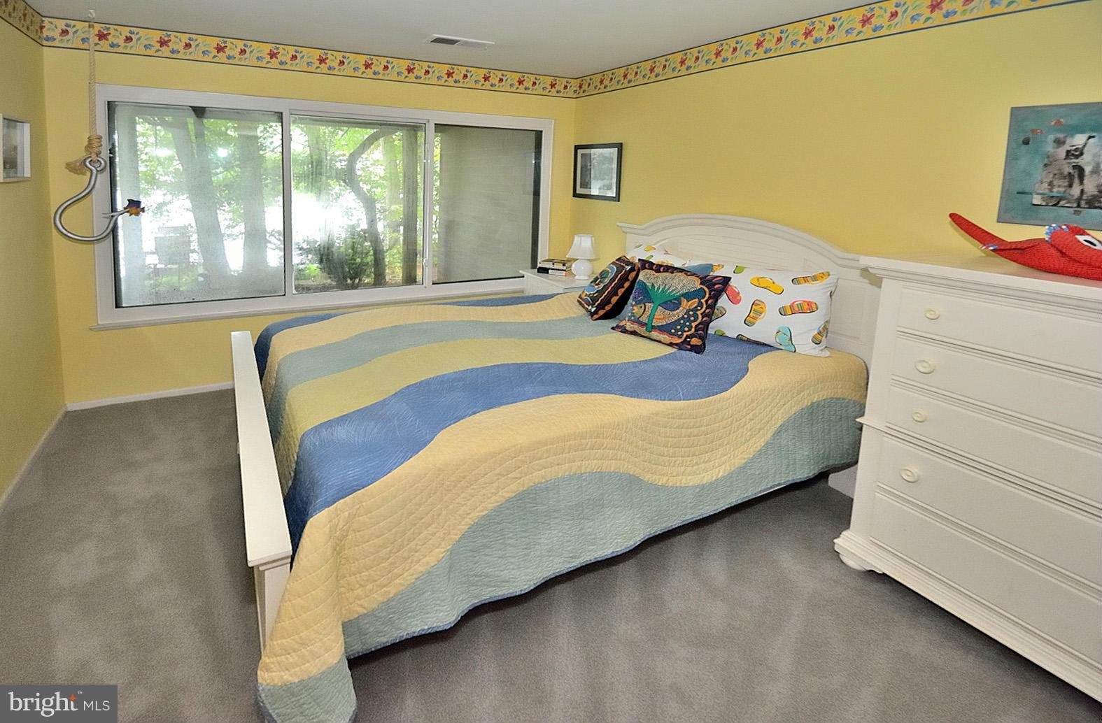 1608 Waters Edge Lane Reston, VA 20190 - Photo 18 of 27 a bed sitting in a bedroom next to a window