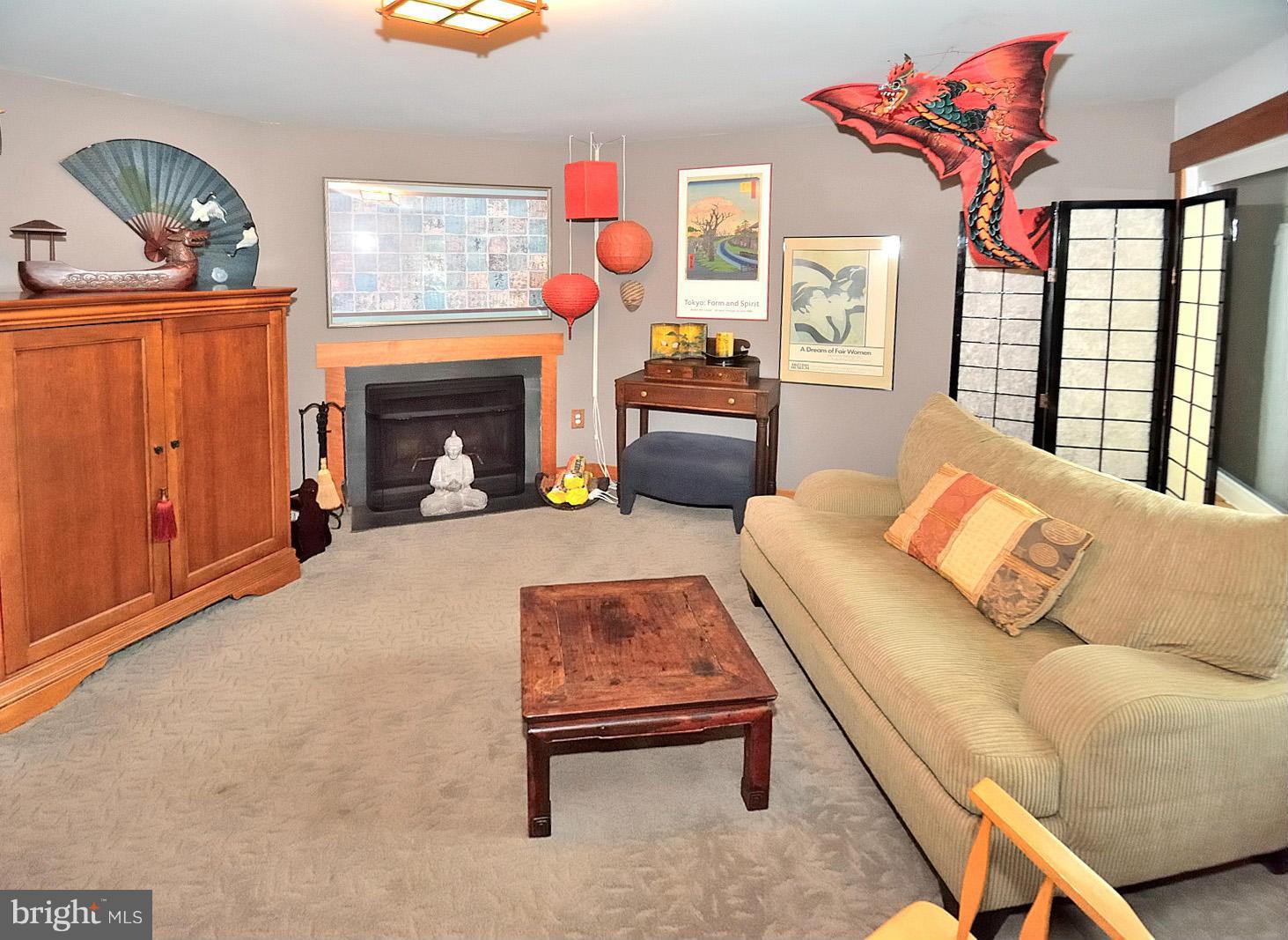 1608 Waters Edge Lane Reston, VA 20190 - Photo 23 of 27 a living room with furniture a fireplace and a flat screen tv