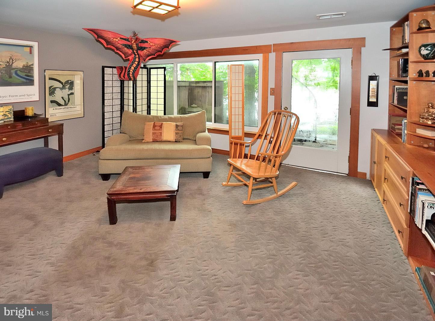 1608 Waters Edge Lane Reston, VA 20190 - Photo 24 of 27 a living room with furniture a bookshelf and a large window